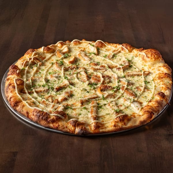 Krave It's chicken bacon ranch pizza, topped with crispy chicken, cheese, ranch drizzle, and parsley.